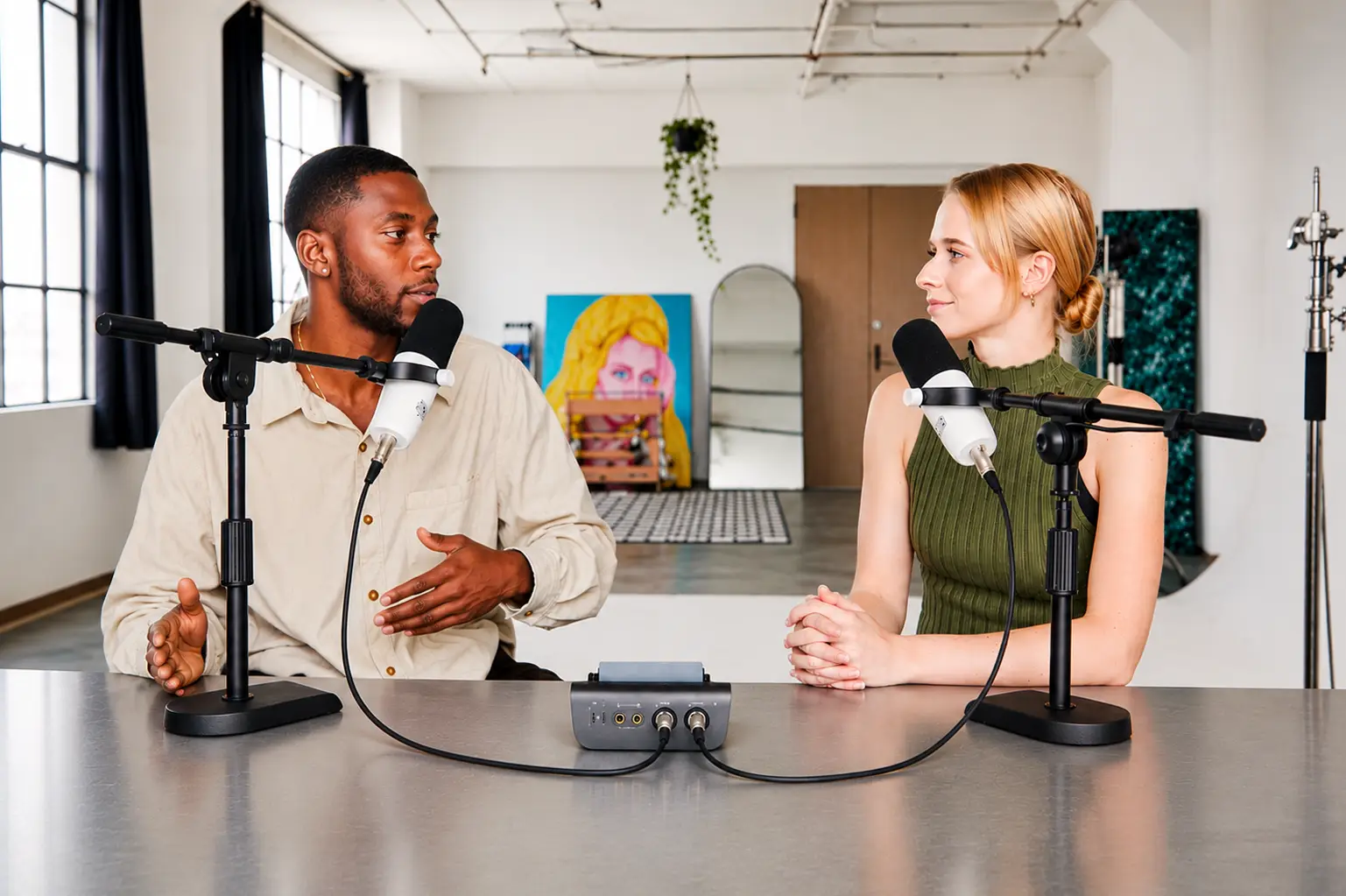 Two creators recording a podcast together in a studio